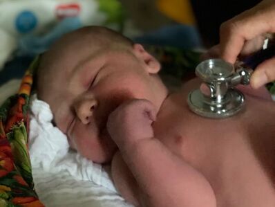 newborn getting heart checked after home birth