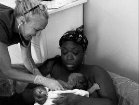 mom holding newborn after water birth